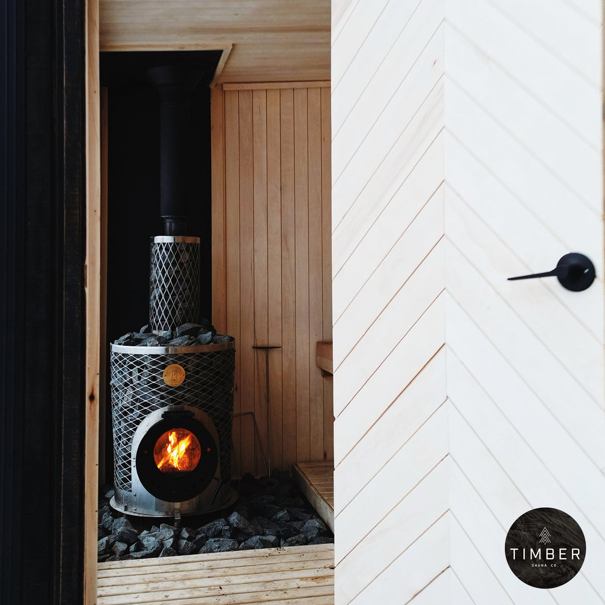 IKI Original Plus wood burning sauna heater in a sauna by Timber Co.